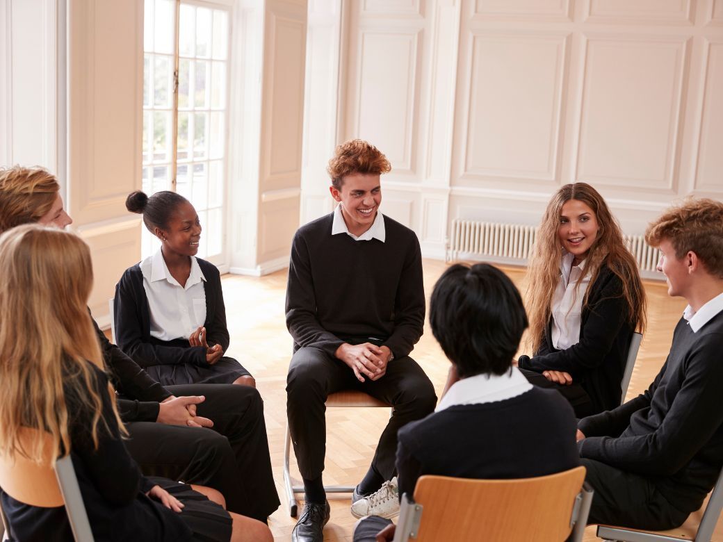 A student leading a debate
